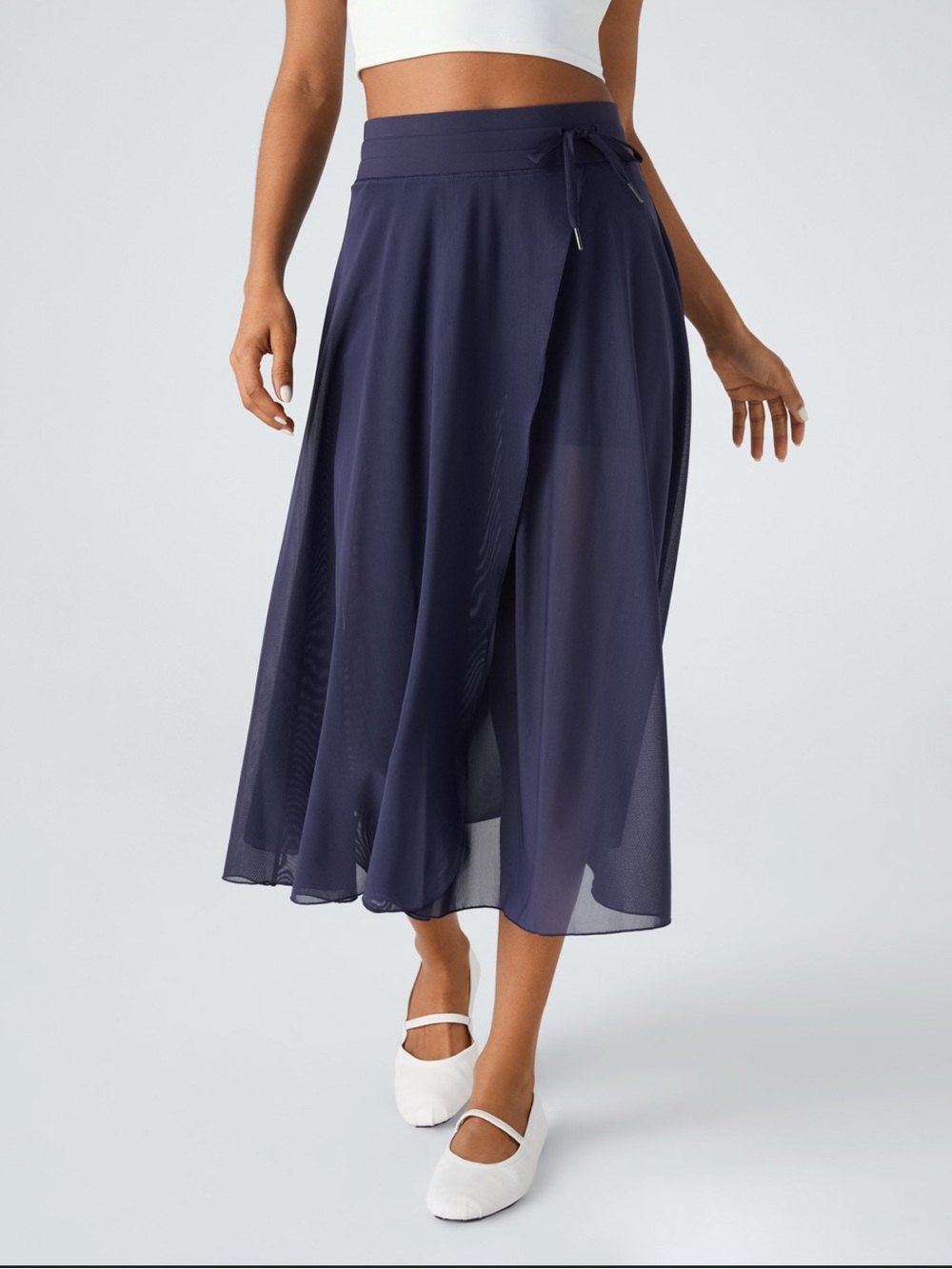 Halara Flowy, casual midi skirt with a flared cut, high waist, and mesh panels S